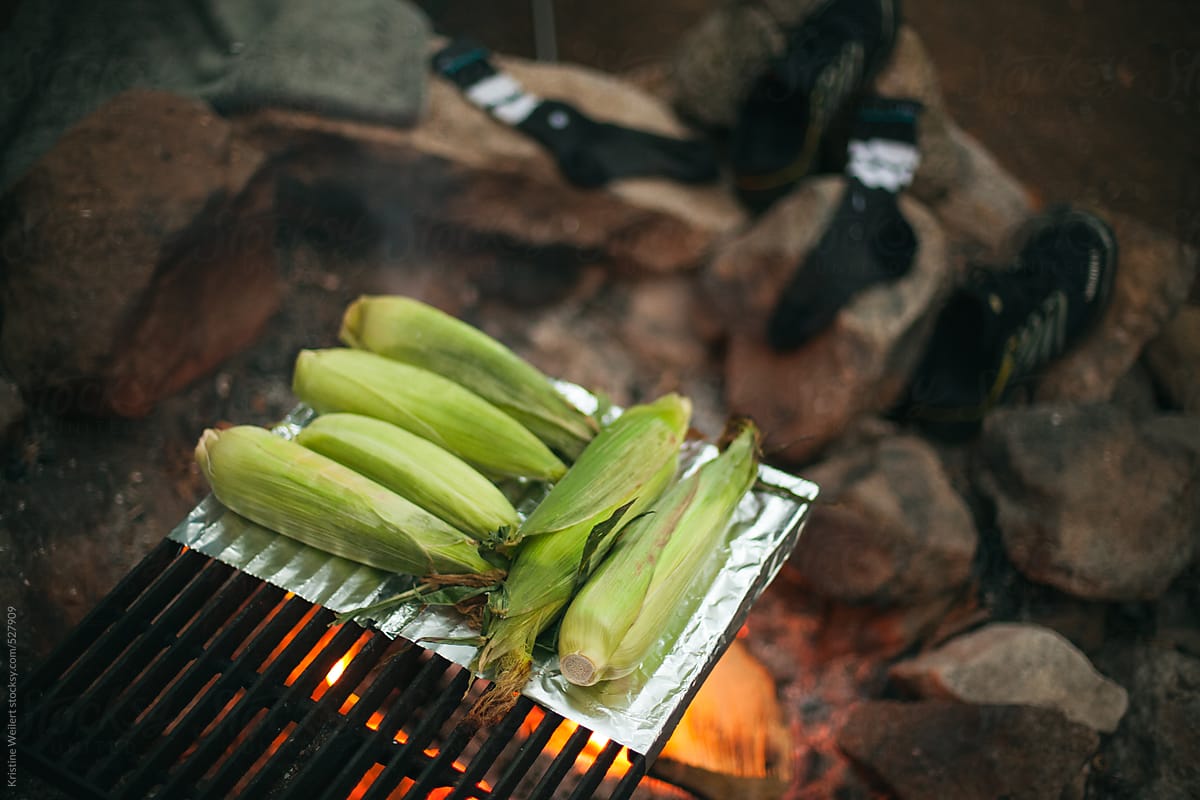 Corn on the cob cooking over a fire