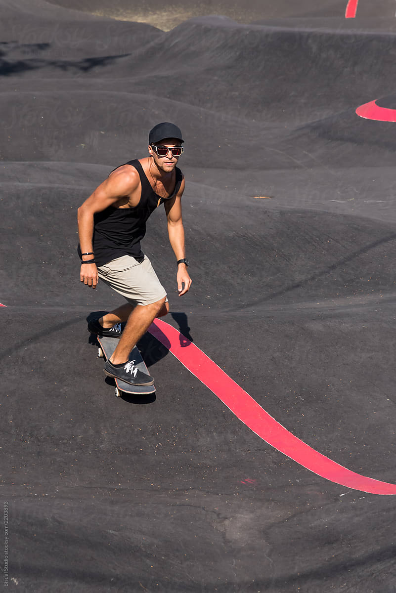 Skateboarder rides a pump track