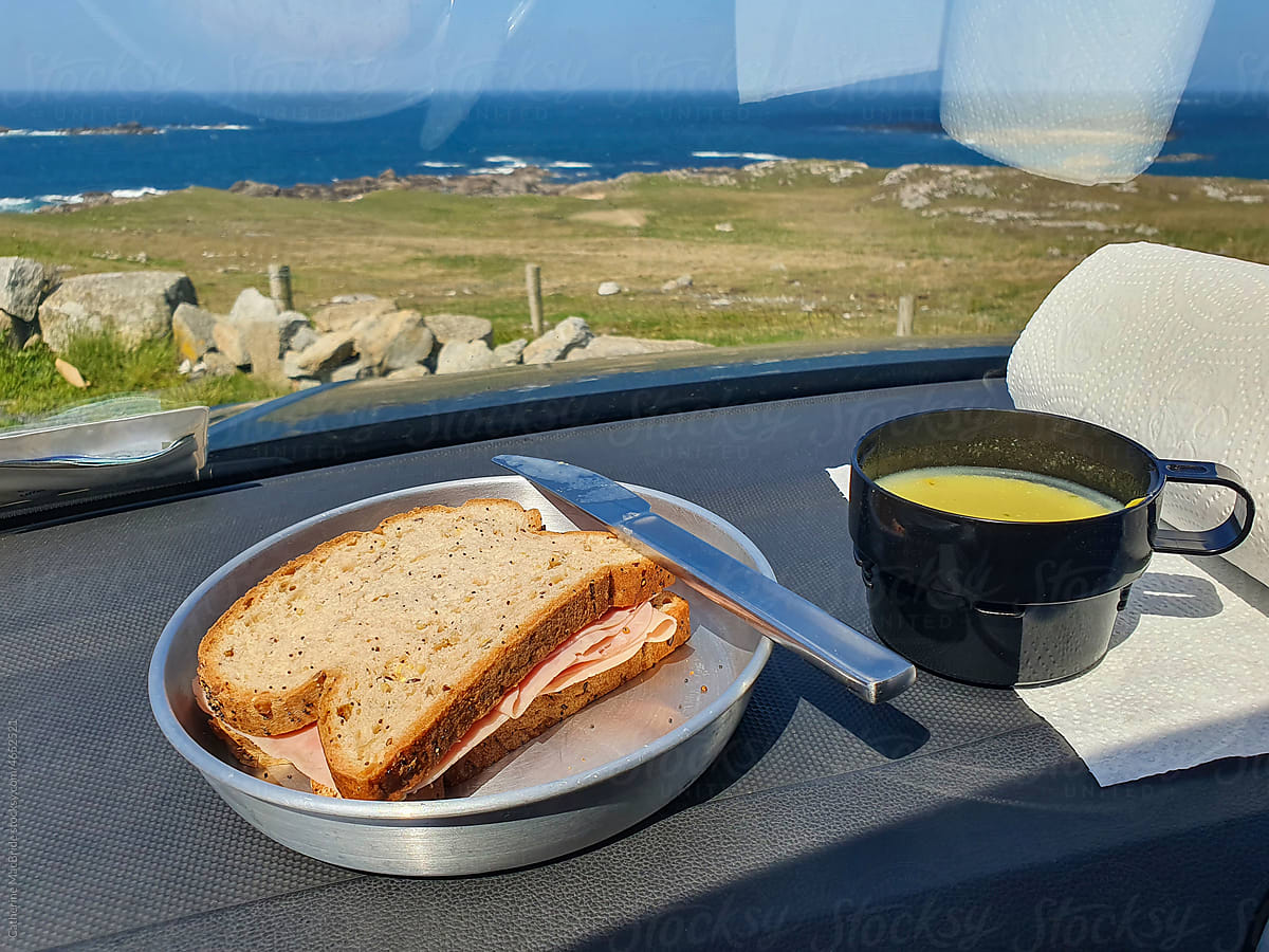 Sandwich and soup in a car by the coast