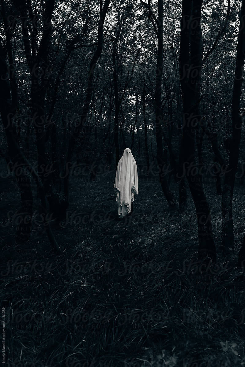 Halloween ghost in a dark forest