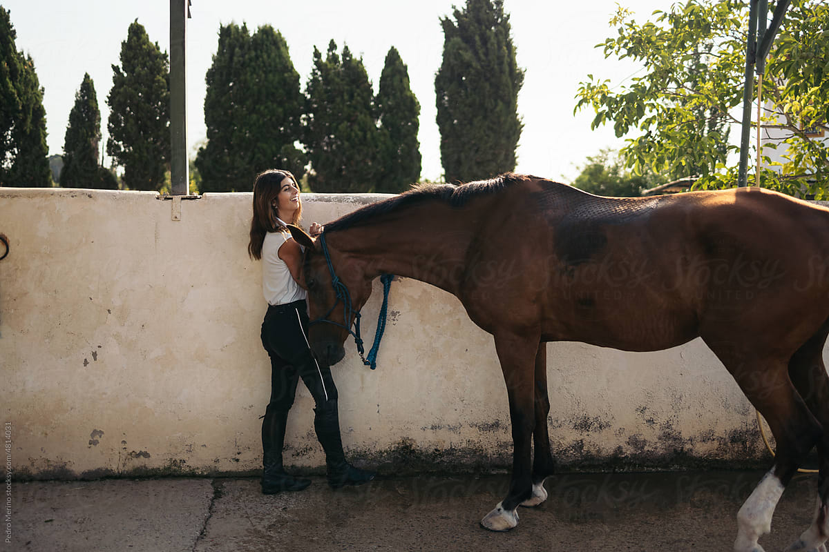 Woman with horse in an equestrian center