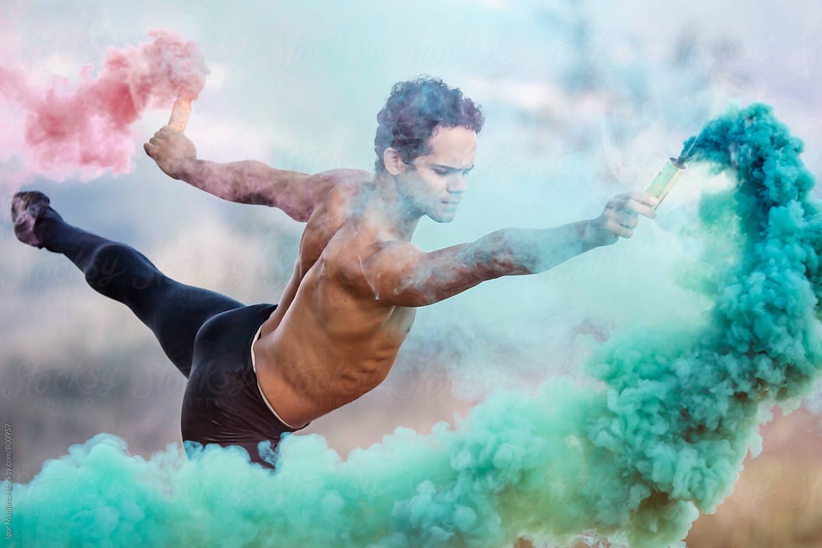 colorful,ballet dancer with two smoke bombs dance in nature