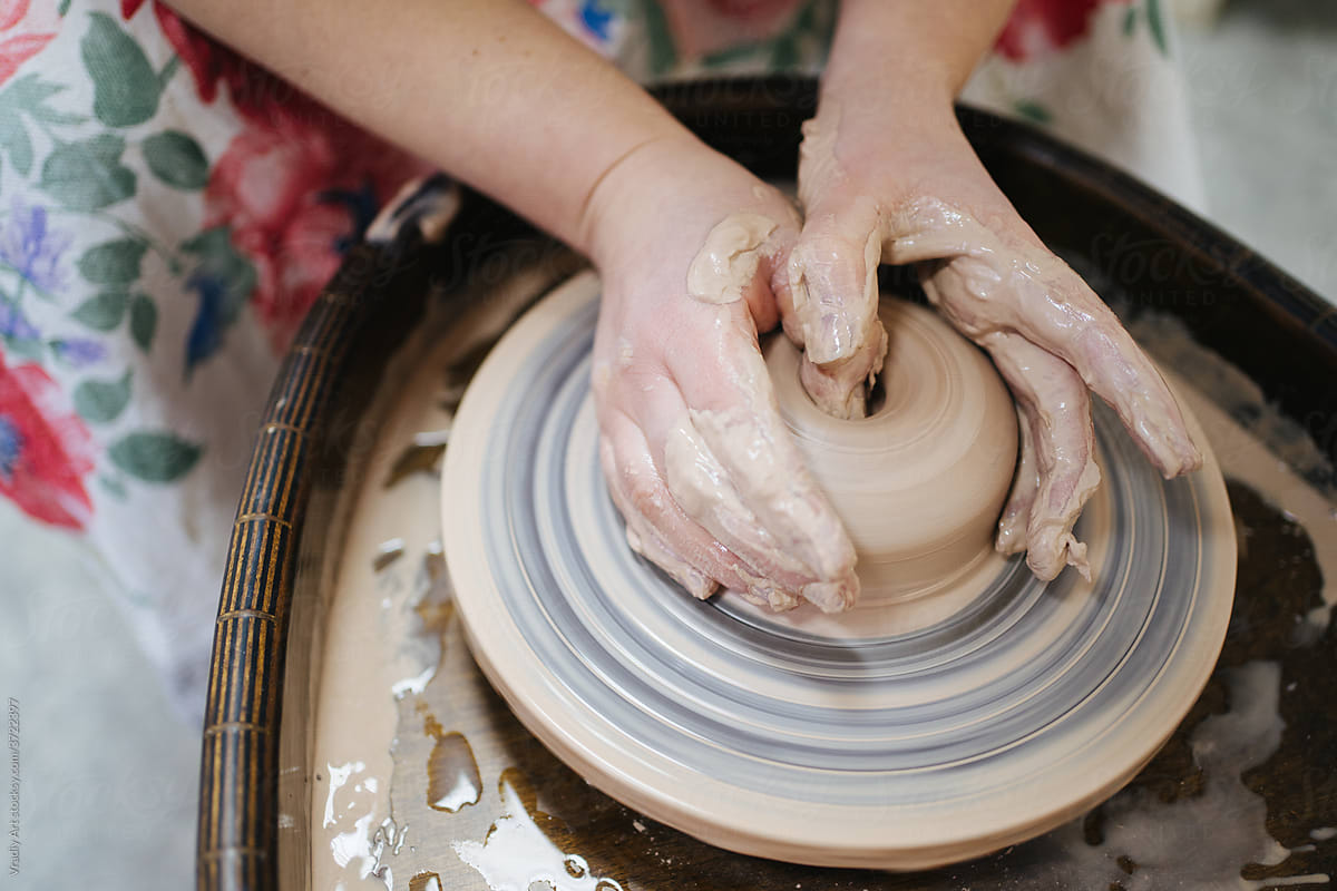 Potter making vessel on wheel