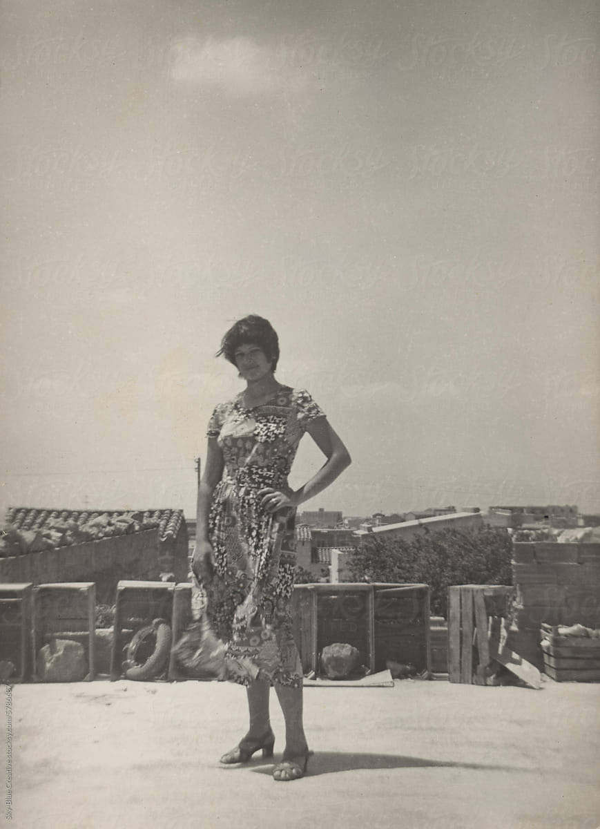 1974. Young woman posing for a photo on the roof of a building