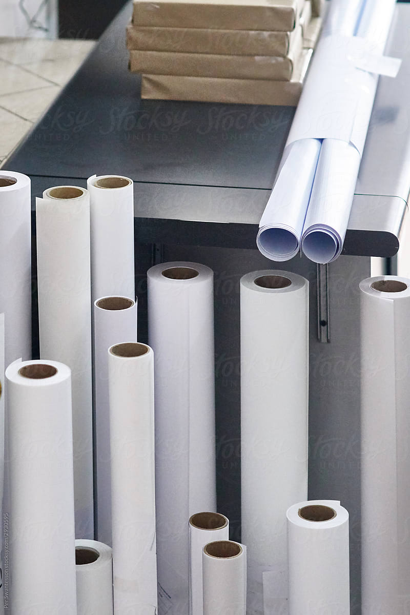 Rolls of white paper in a print shop
