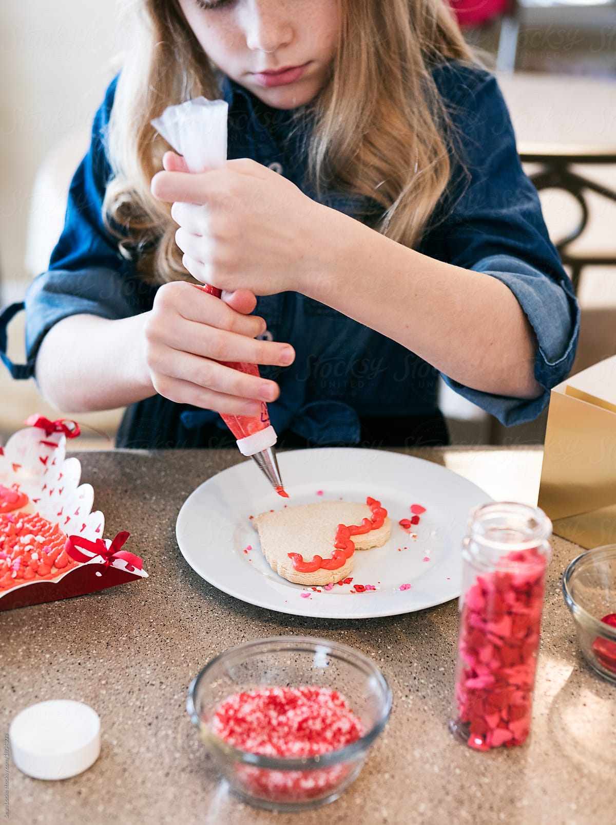 Valentine: Girl Outlining Heart Cookie With Buttercream