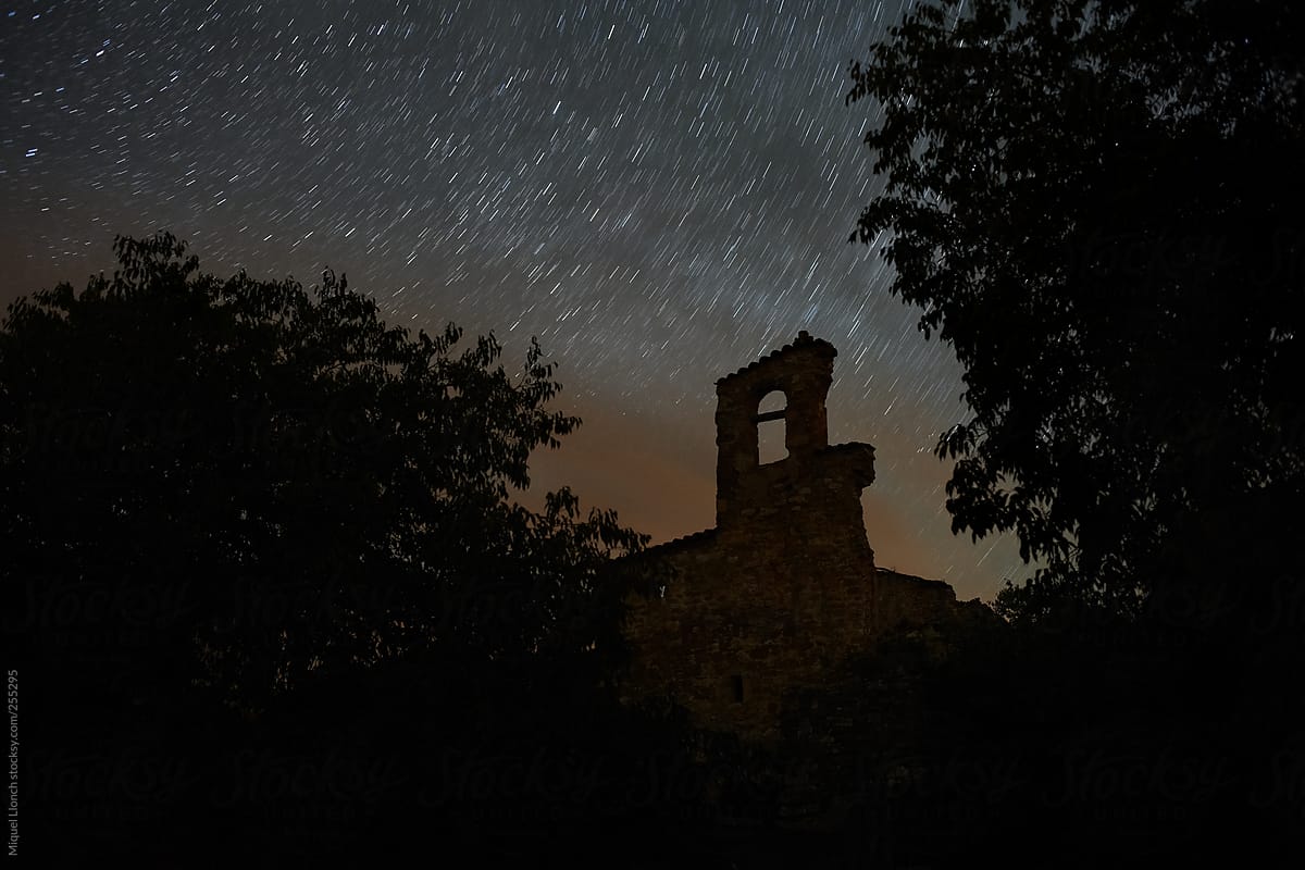Silhouette of old church and trees with nightsky
