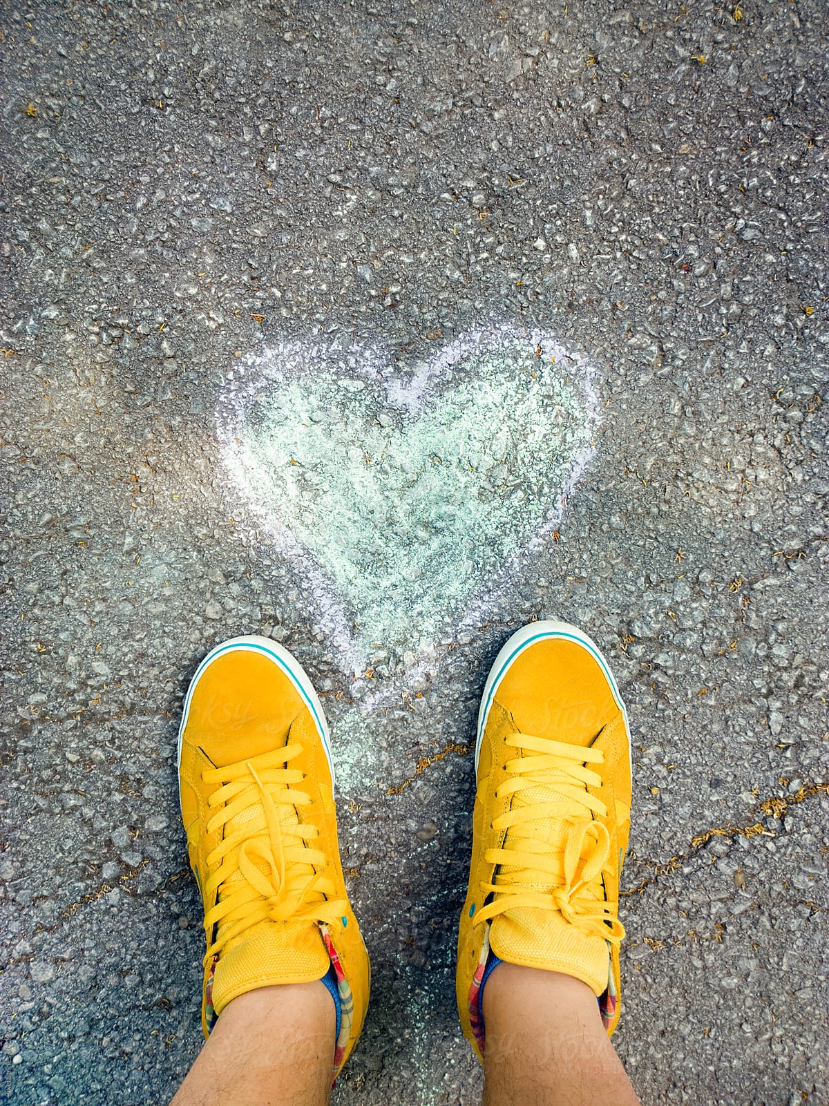 First-person view of feet standing in front of heart