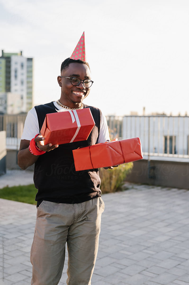 Cheerful black man with wrapped presents