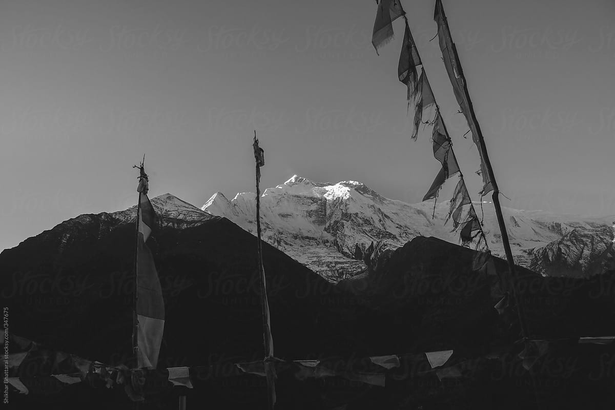 Black and white scenic landscape of himalaya with prayer flags.