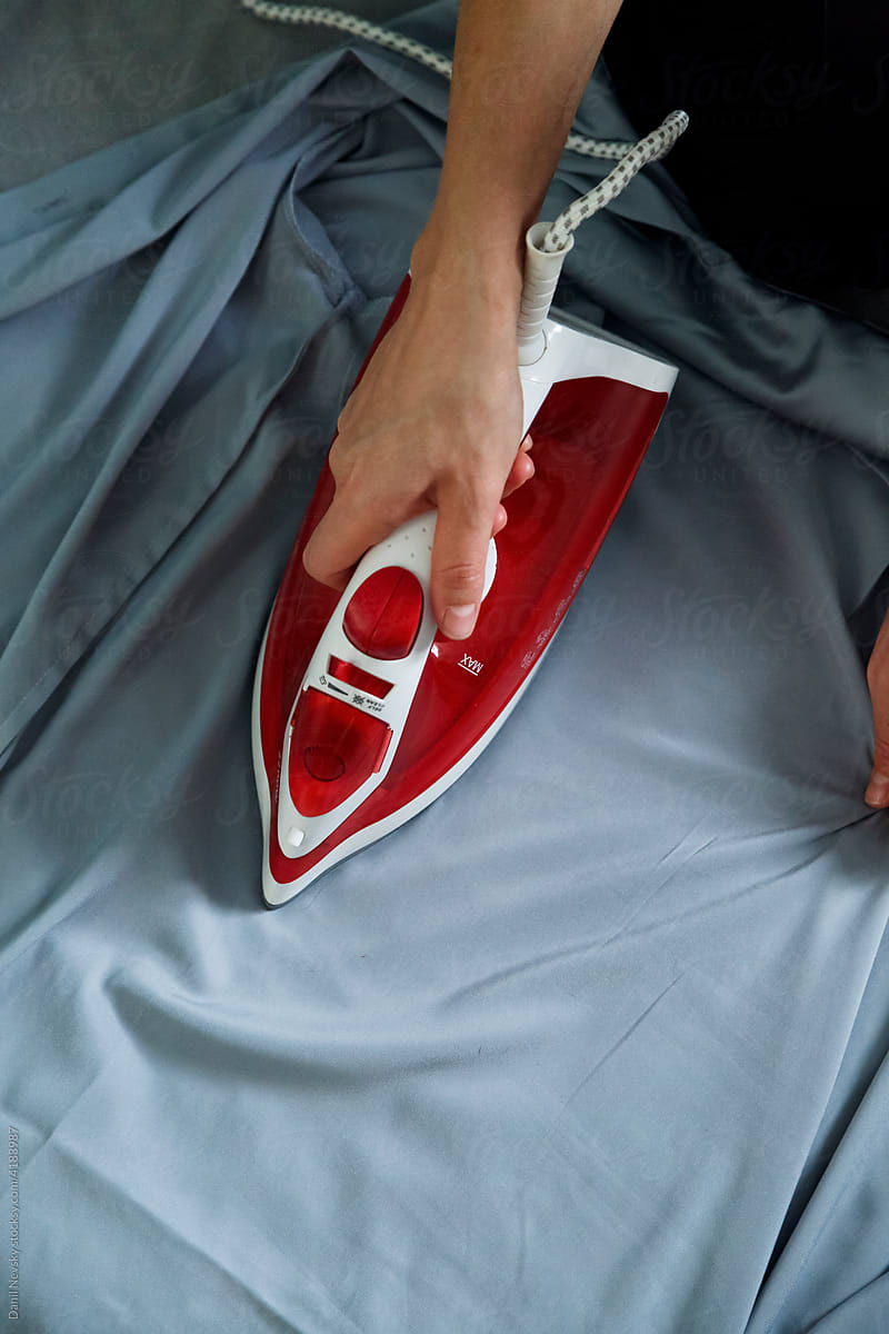 Woman ironing wrinkled shirt