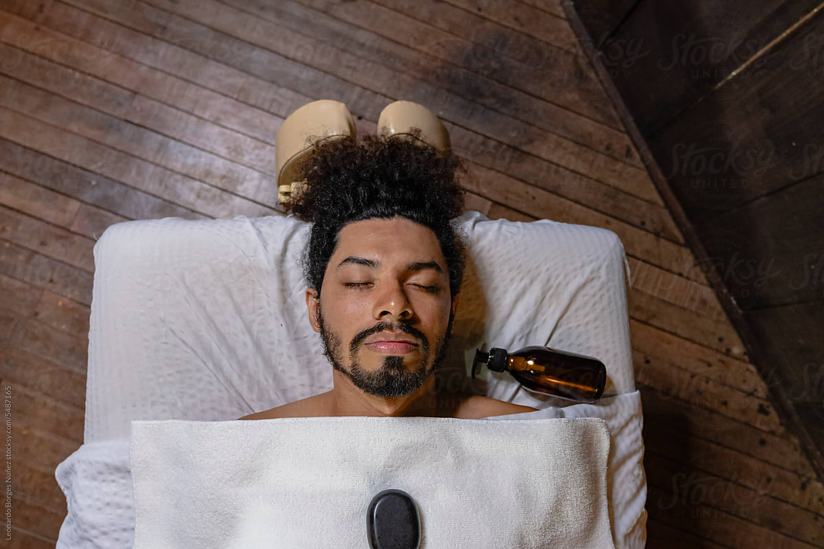 Man asleep on a massage table.