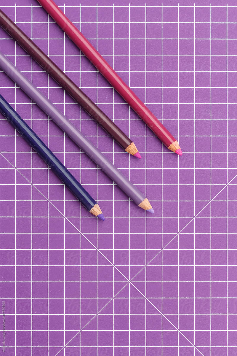 purple coloured pencils on a purple grid background
