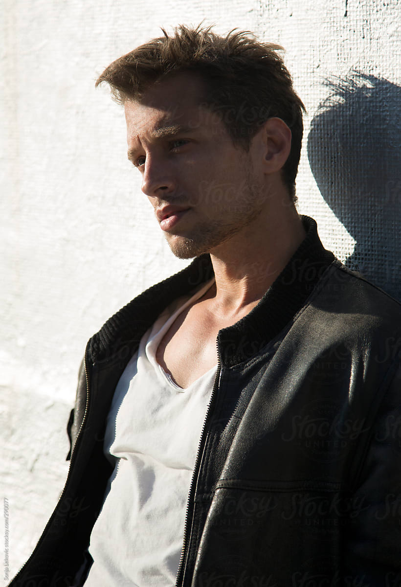 Handsome Man In Black Leather Jacket And White T-shirt" by Stocksy Contributor "Sonja Lekovic" -