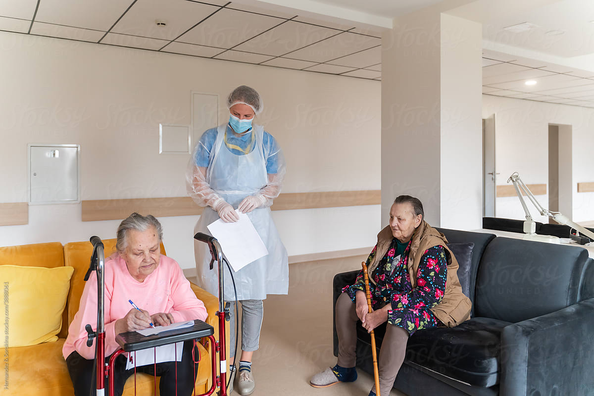 Old Woman Signing Document At Nursing Home