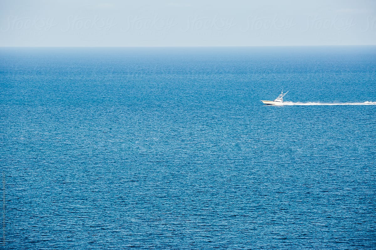 Speedboat Sailing Through The Blue Sea In The Ocean On A Clear Day By Stocksy Contributor