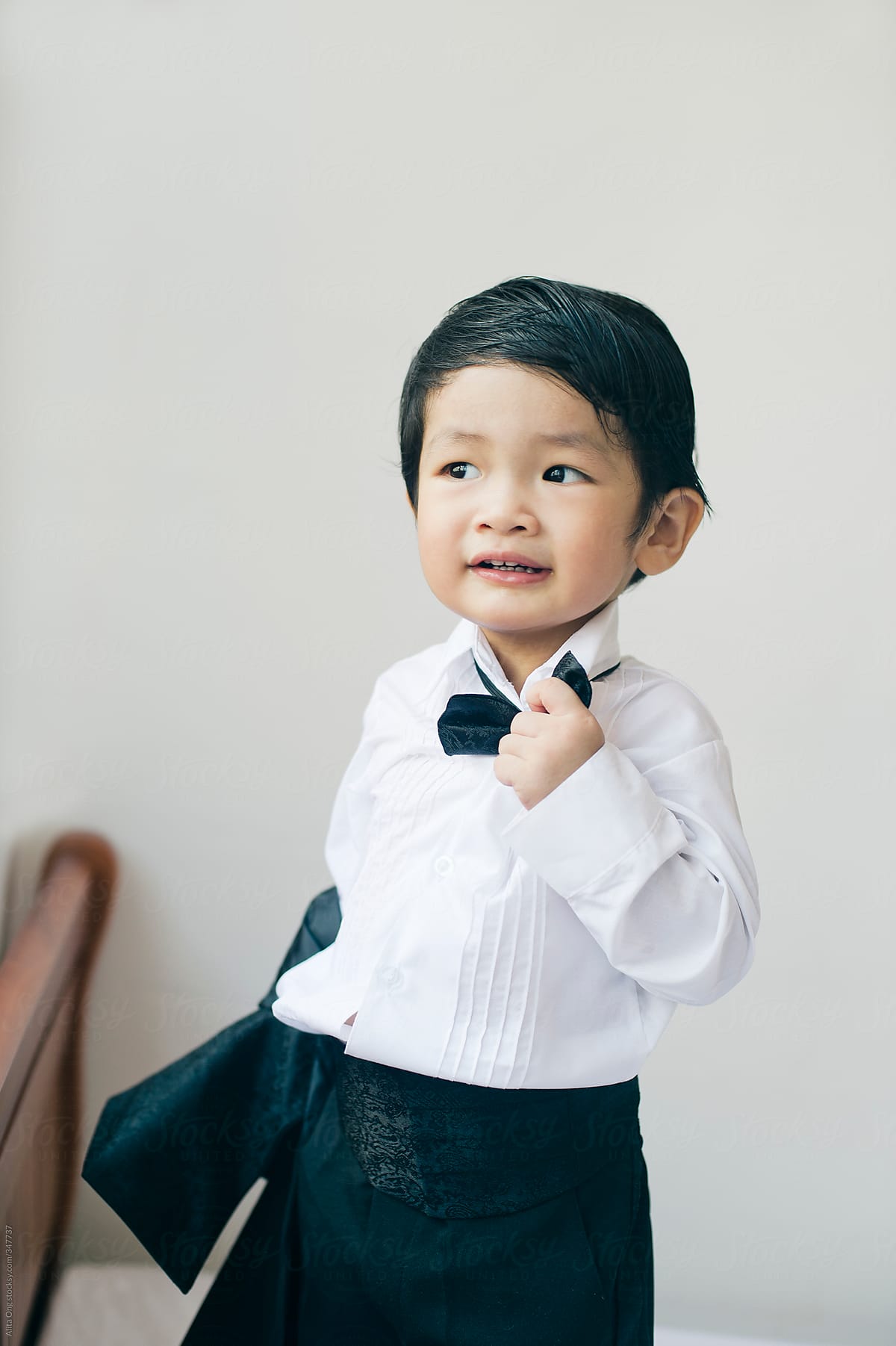 Asian toddler in tuxedo