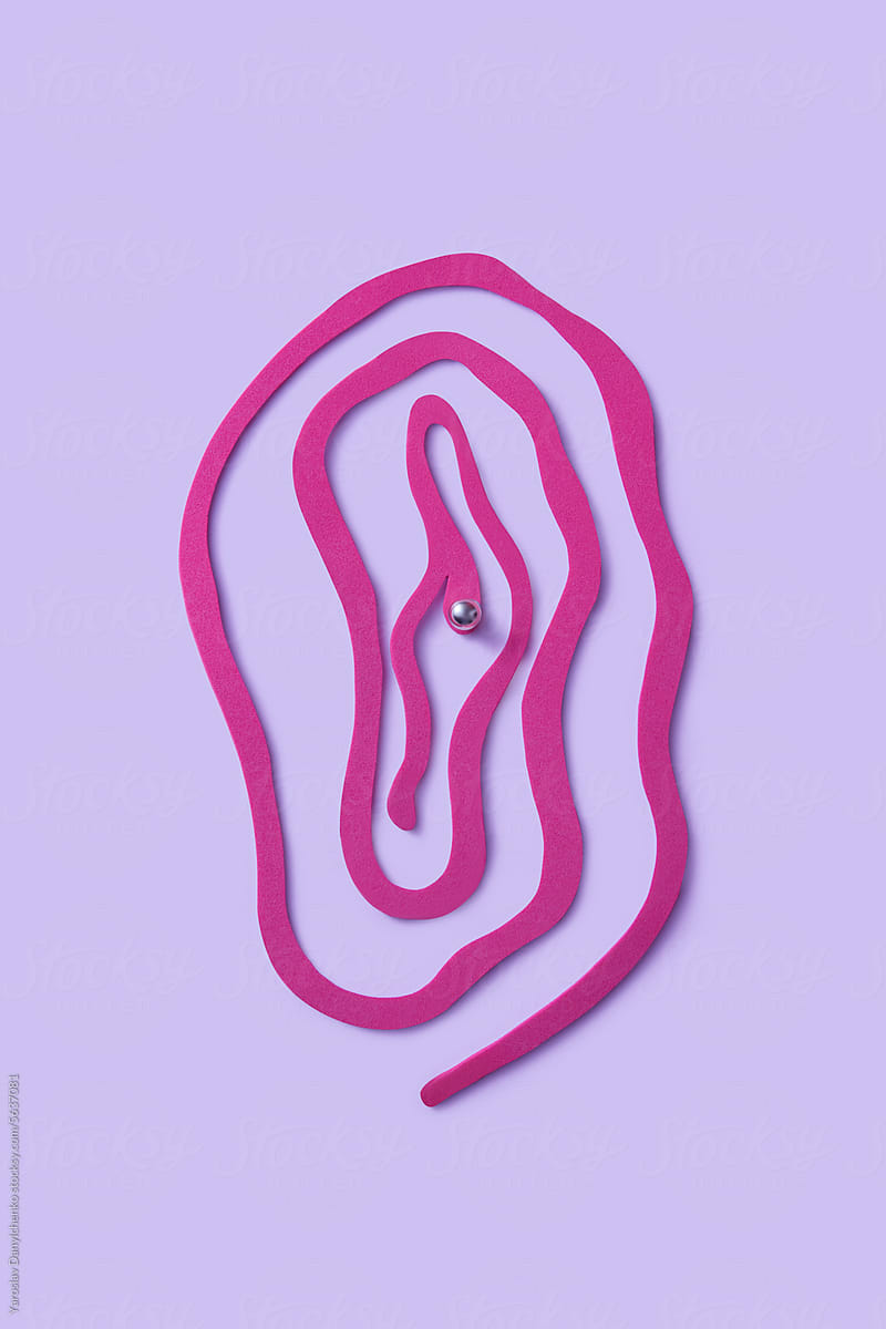 Curved cut paper shaped in female vagina with piercing on clitoris