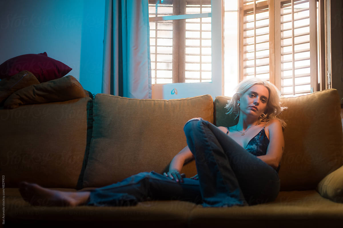 Portrait of stylish blonde woman on the sofa