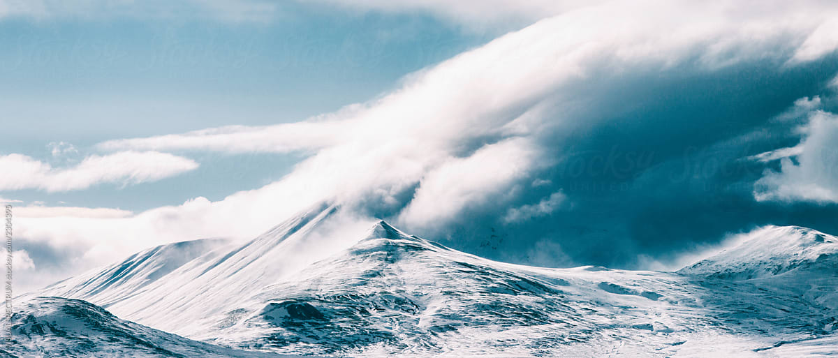 Massive Cloud Formation Surrounding Peak in Sunny Icelandic Highlands