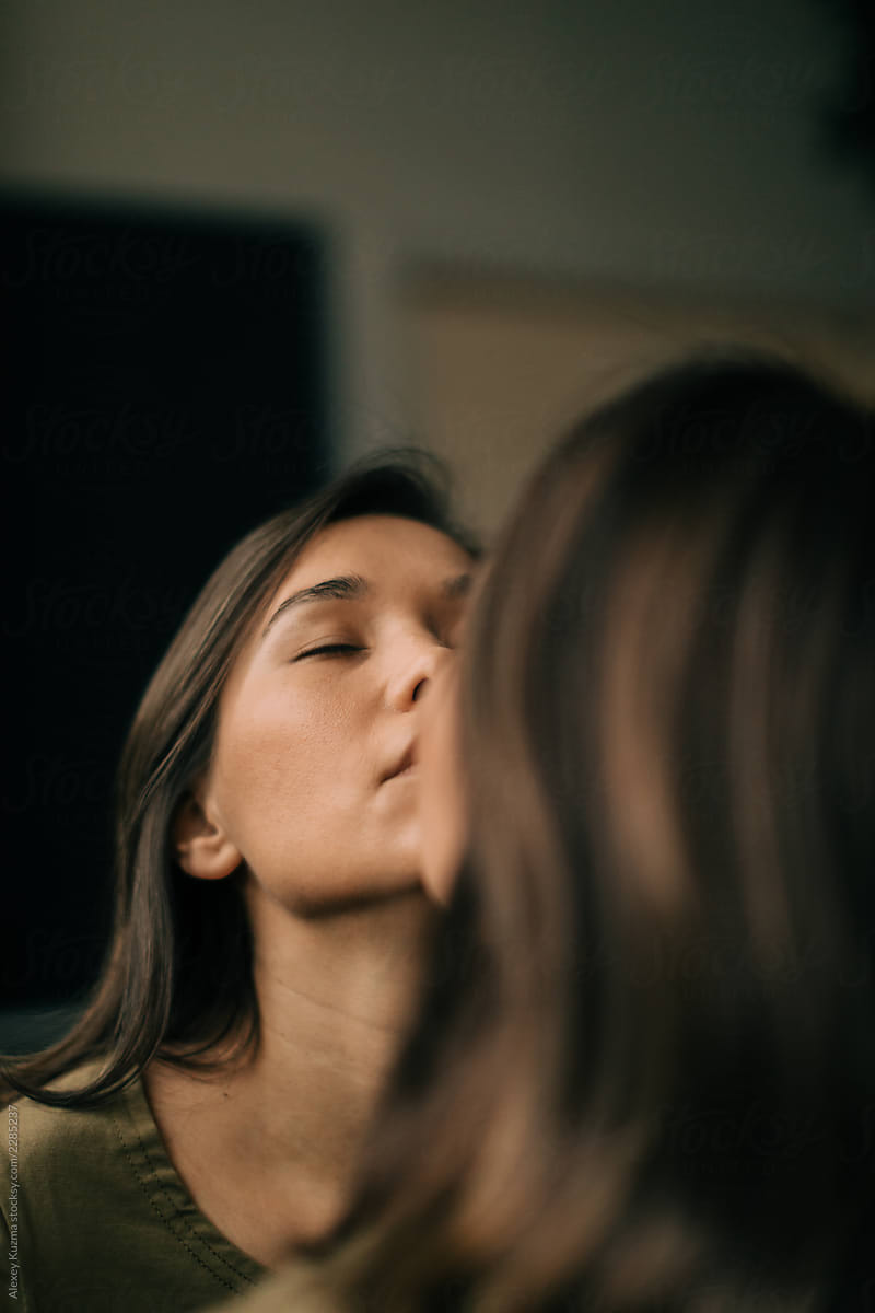 Young Woman Kissing Her Reflection In The Mirror