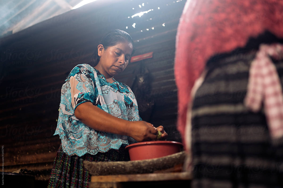 Young guatemalan woman preparing traditional food