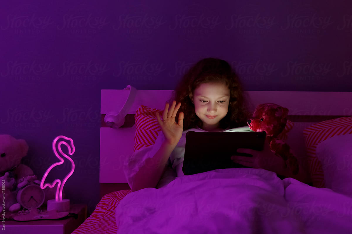 Happy girl greeting online friend at night
