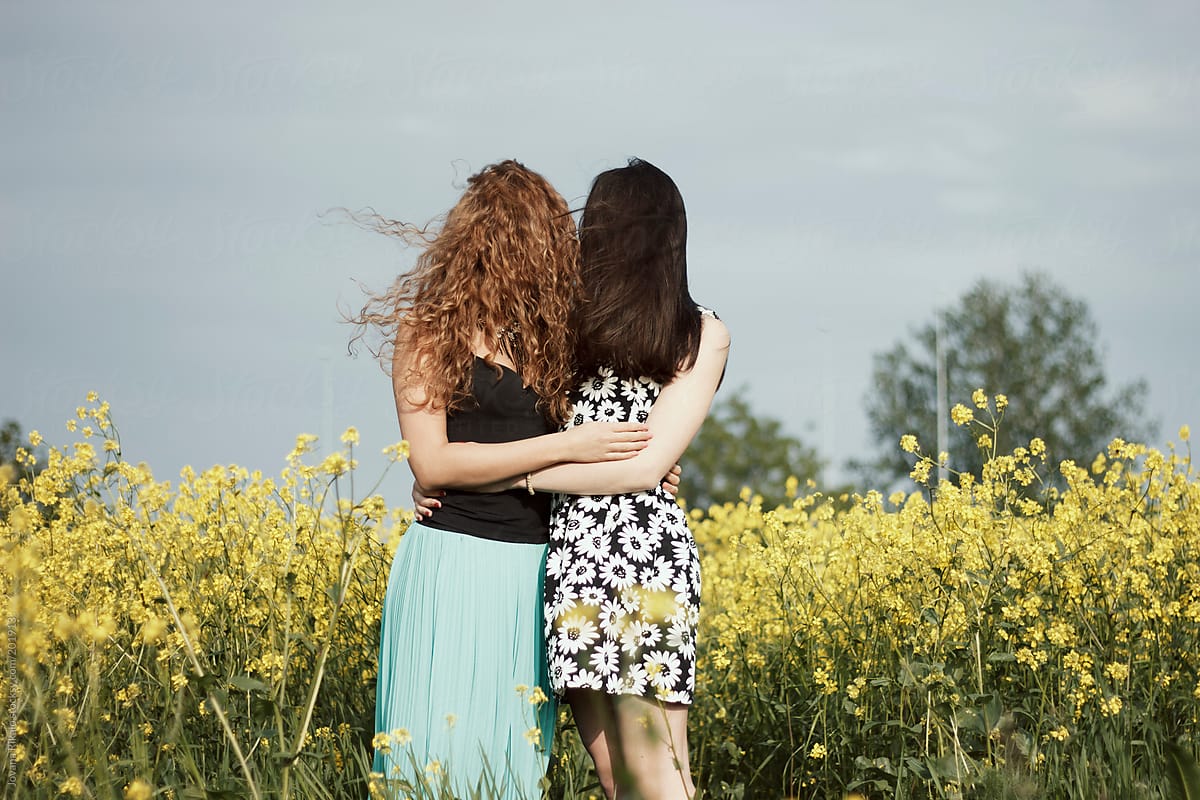 Two Young Woman Hugging Each Other With Hair Covering Their Face By Stocksy Contributor 