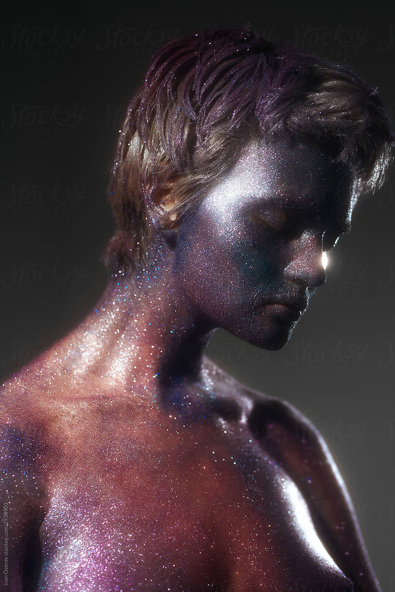 sensual portrait of a girl with space bodypainting in the studio
