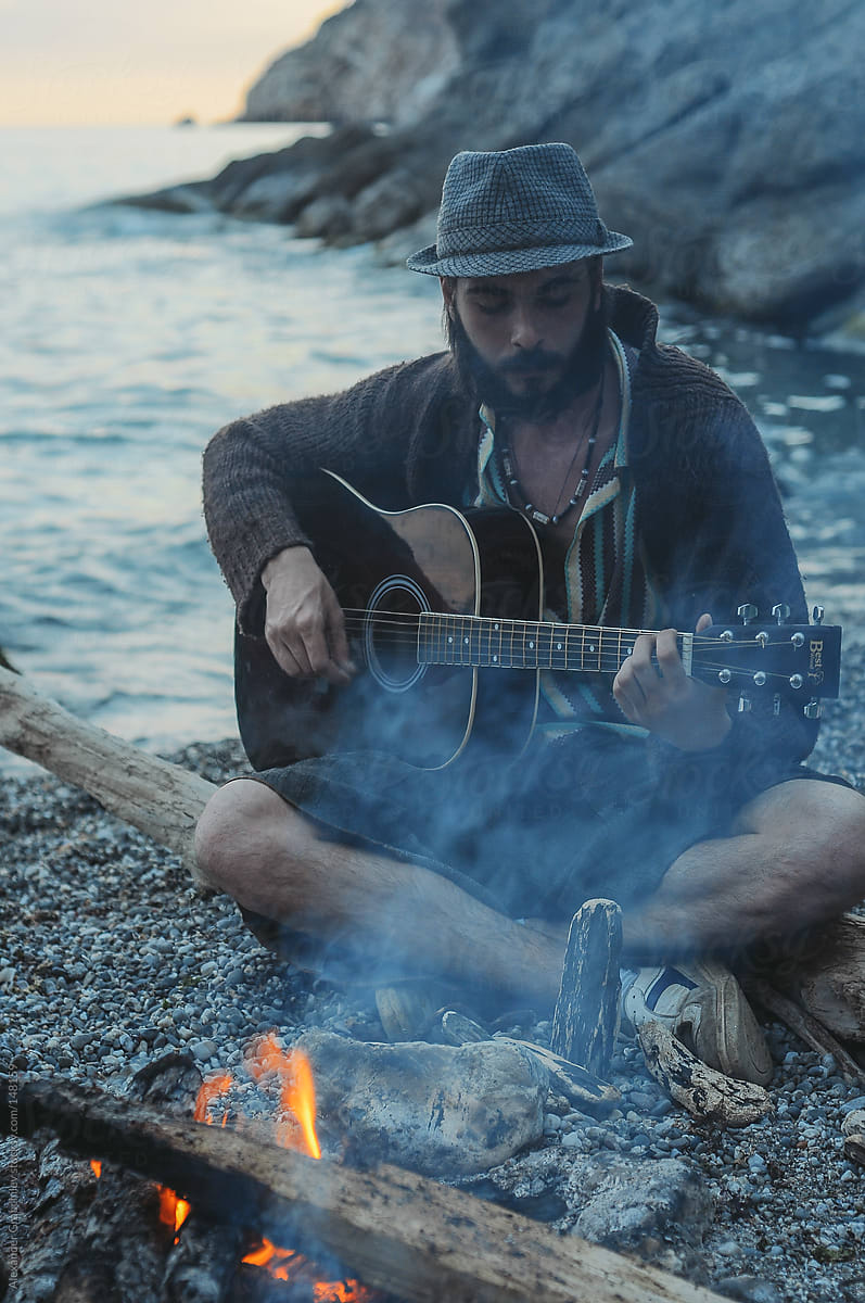 Man Playing Guitar on the Beach