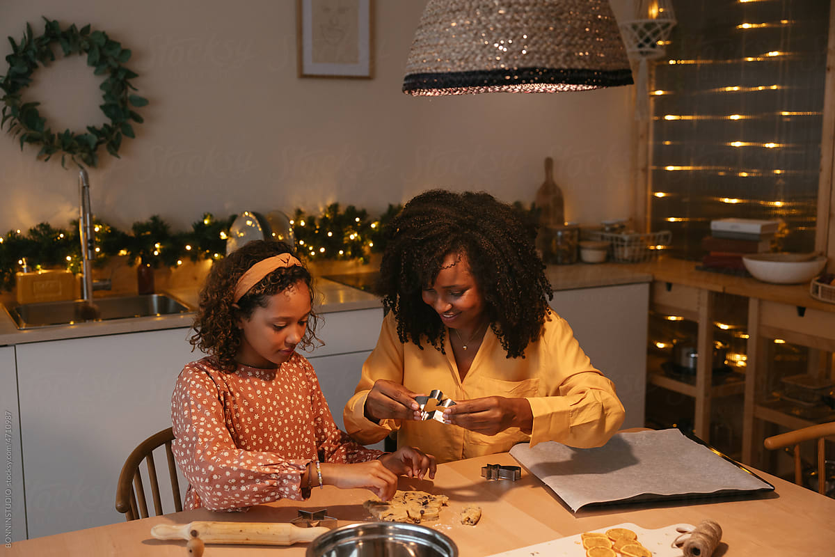 Mother with their daughter preparing Christmas cookies