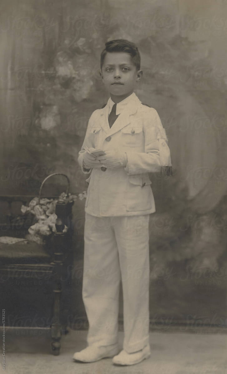 1943. Boy poses for his First Communion photo.
