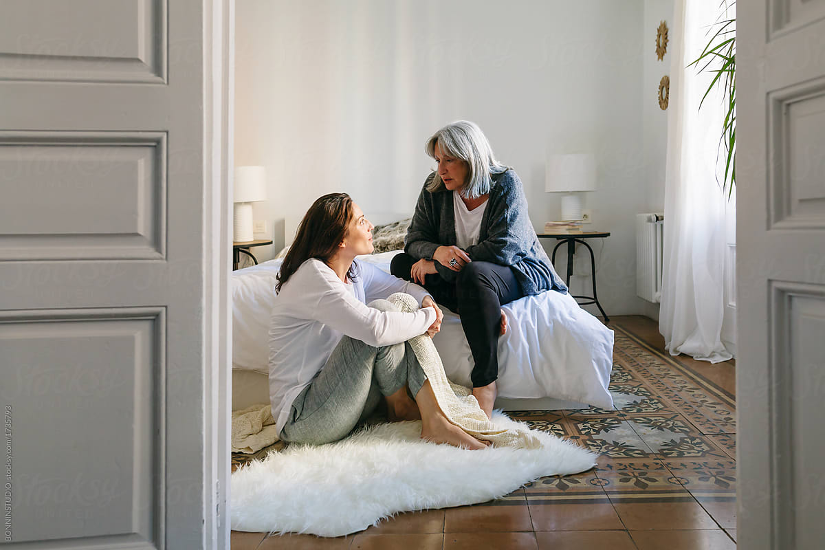 Mother And Her Daughter Talking Together On The Room At Morning By Stocksy Contributor