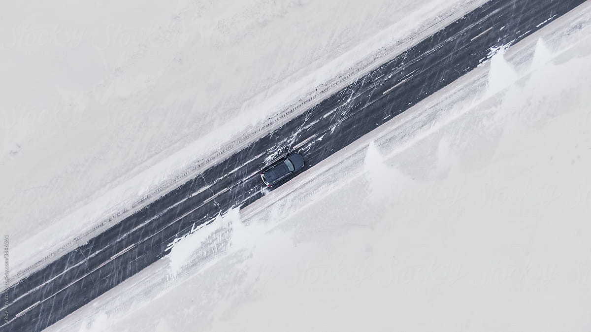 Overhead view Of a brand new black Car on a winter road