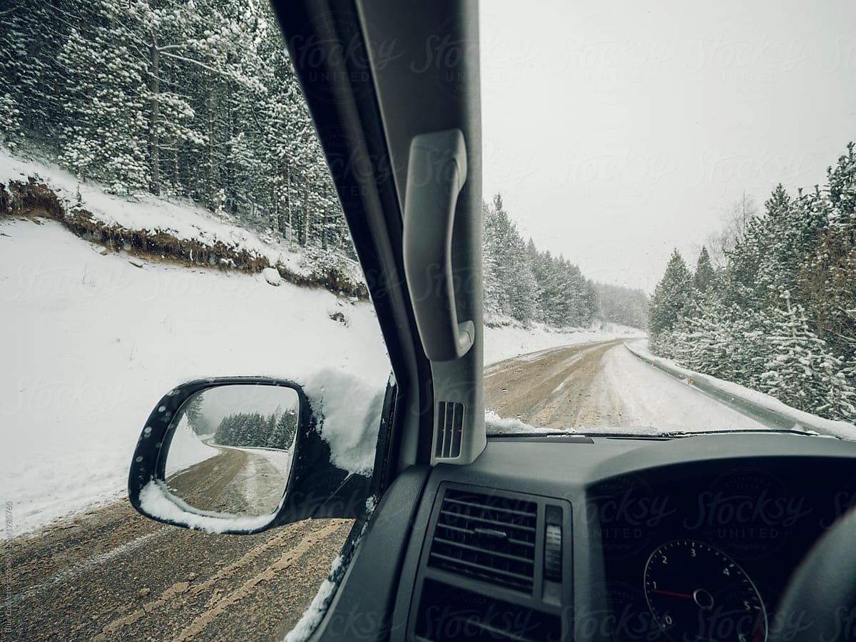 view from inside the car on the snowy road mountain