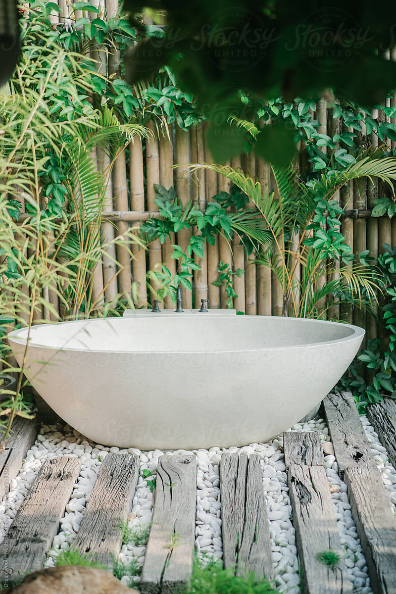 White bathtub in tropical spa salon outdoors