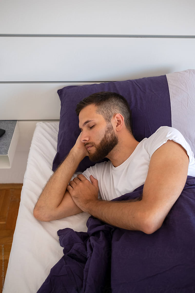 Close-up of a young bearded male model sleeping in the morning