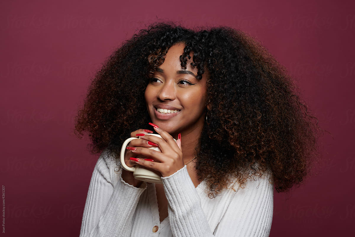 Black Curly Hair Woman smilling  With A Tea Cup In Hand