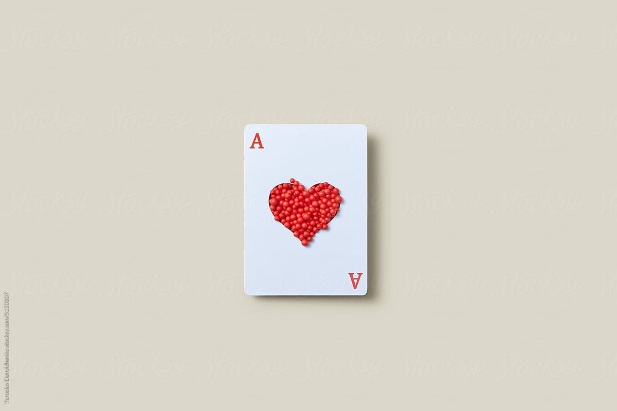 Card with red balls in heart-shaped opening.