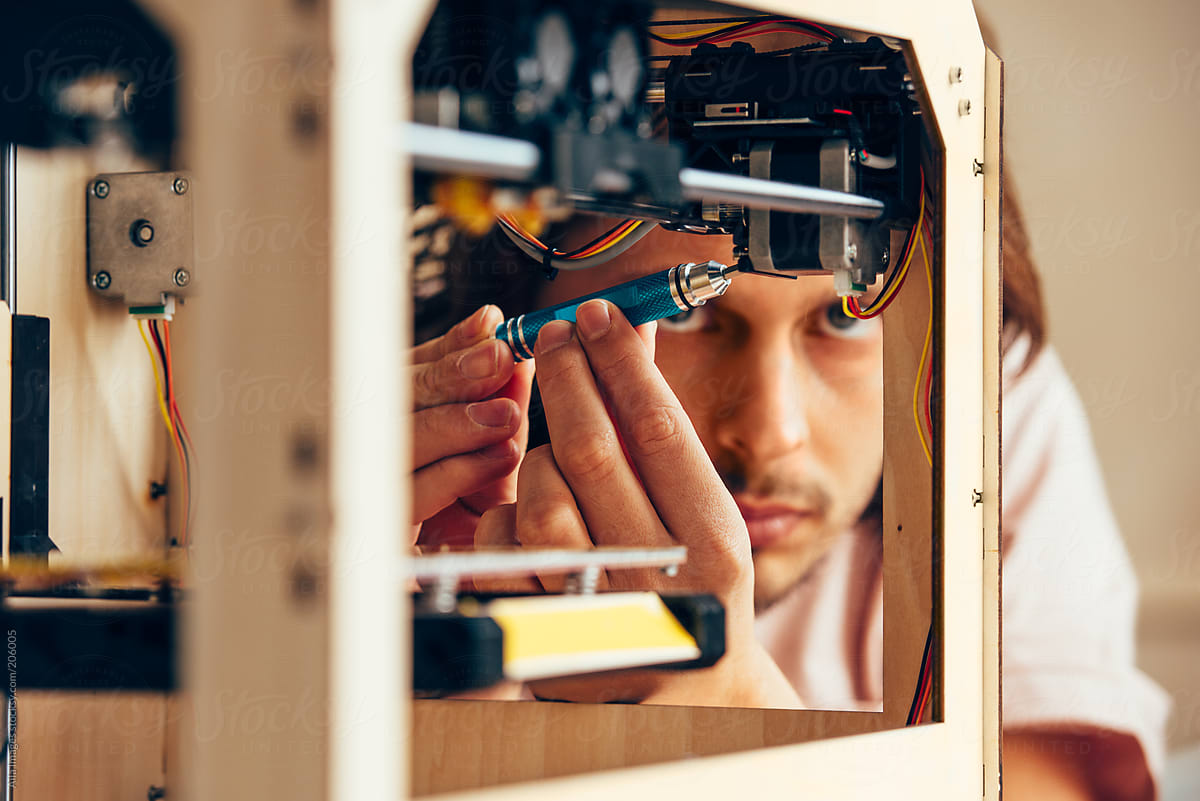 Technician working with 3D printer