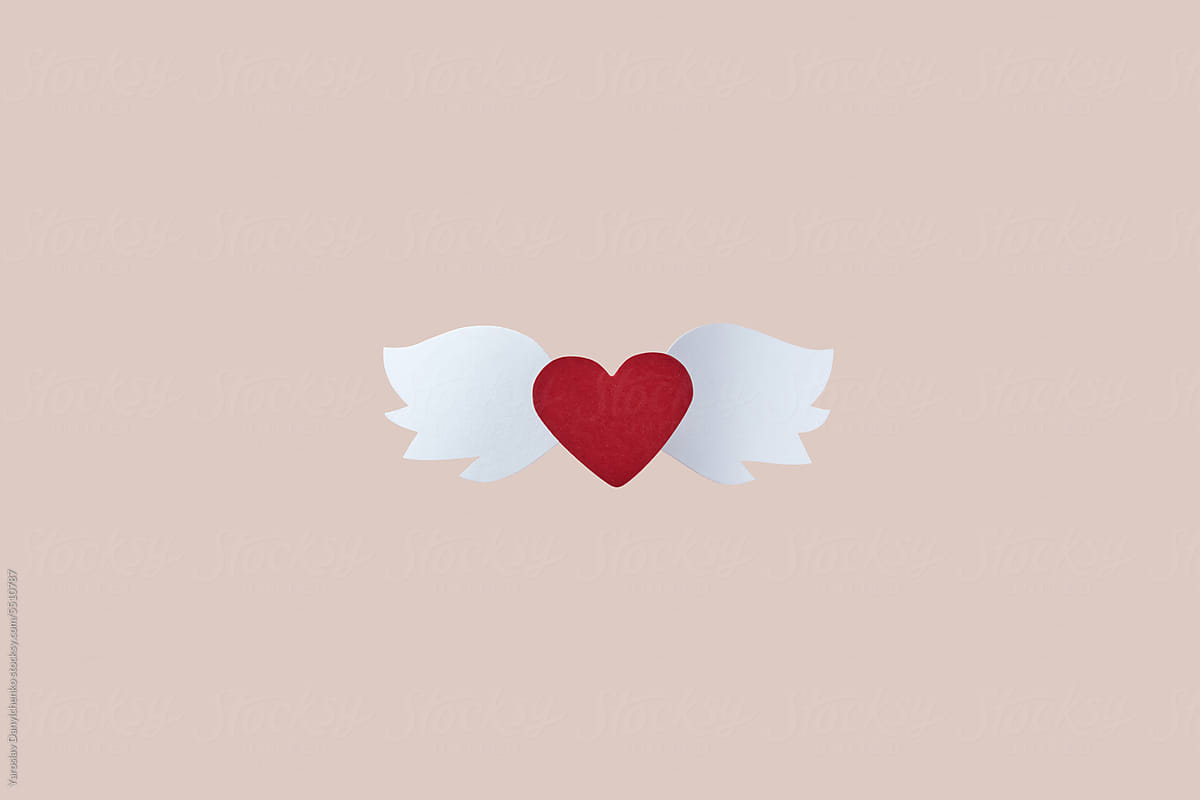 Crafted red paper heart with white wings.