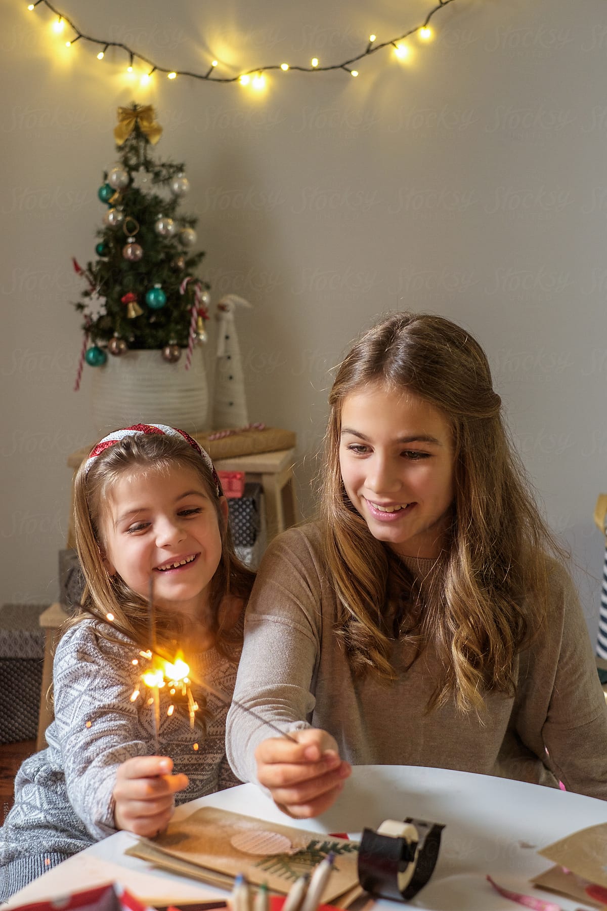 Two Smiling Little Girls Holding Sparkles Sticks