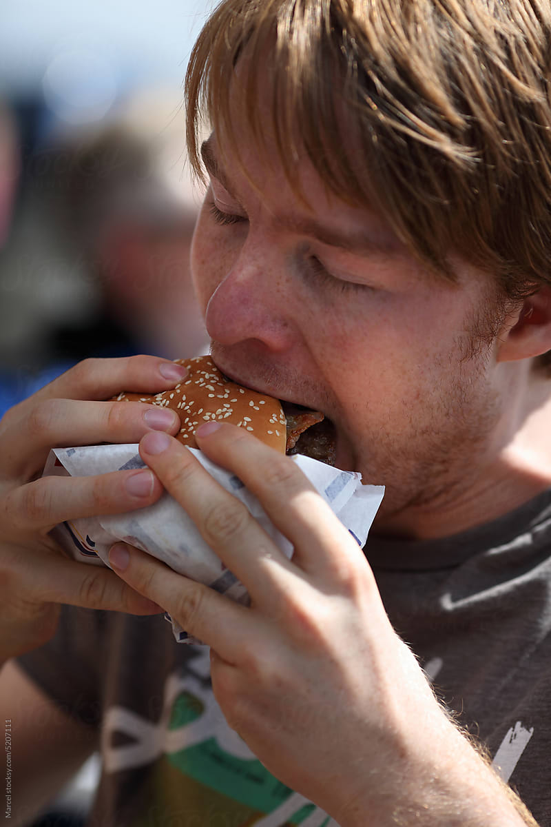 Young man eating a burger
