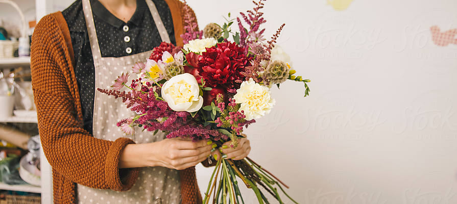 Professional Florist Girl Collecting Flowers by Stocksy