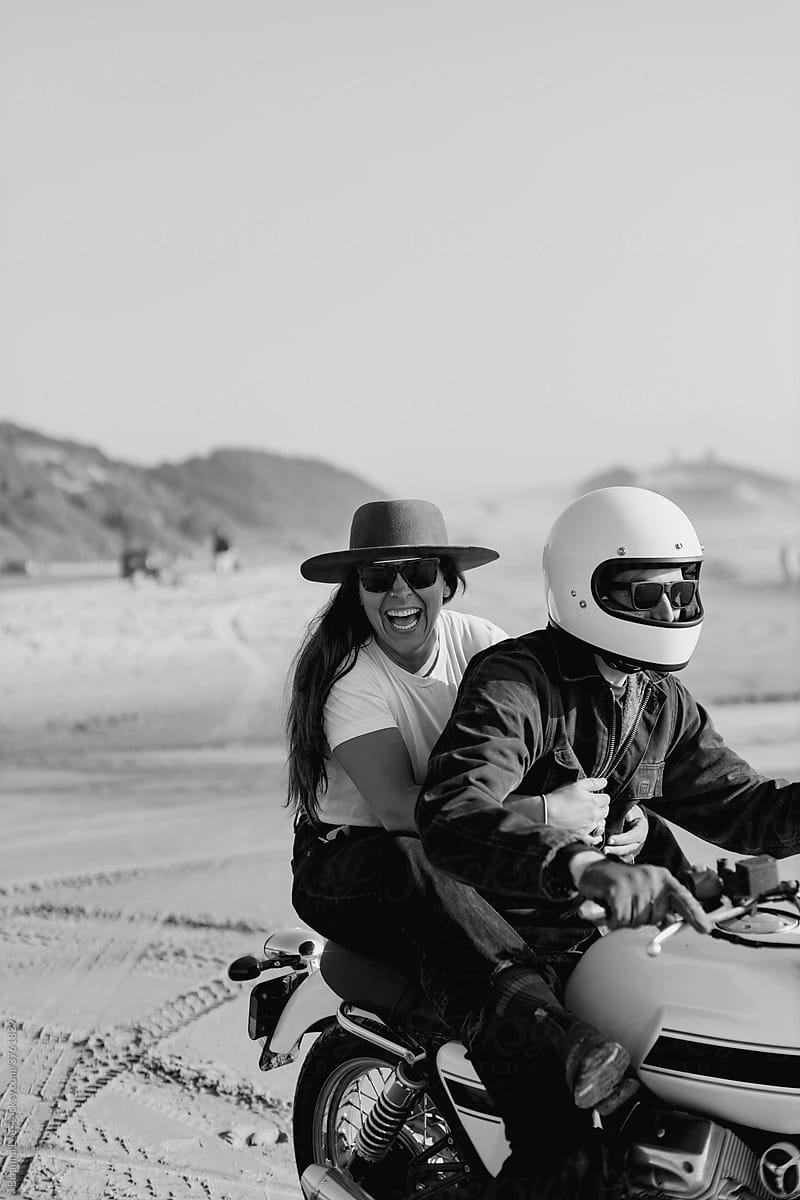 Trendy Couple with Motorcycle on Beach