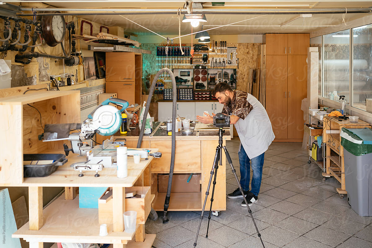Artisan shooting video on camera in workshop