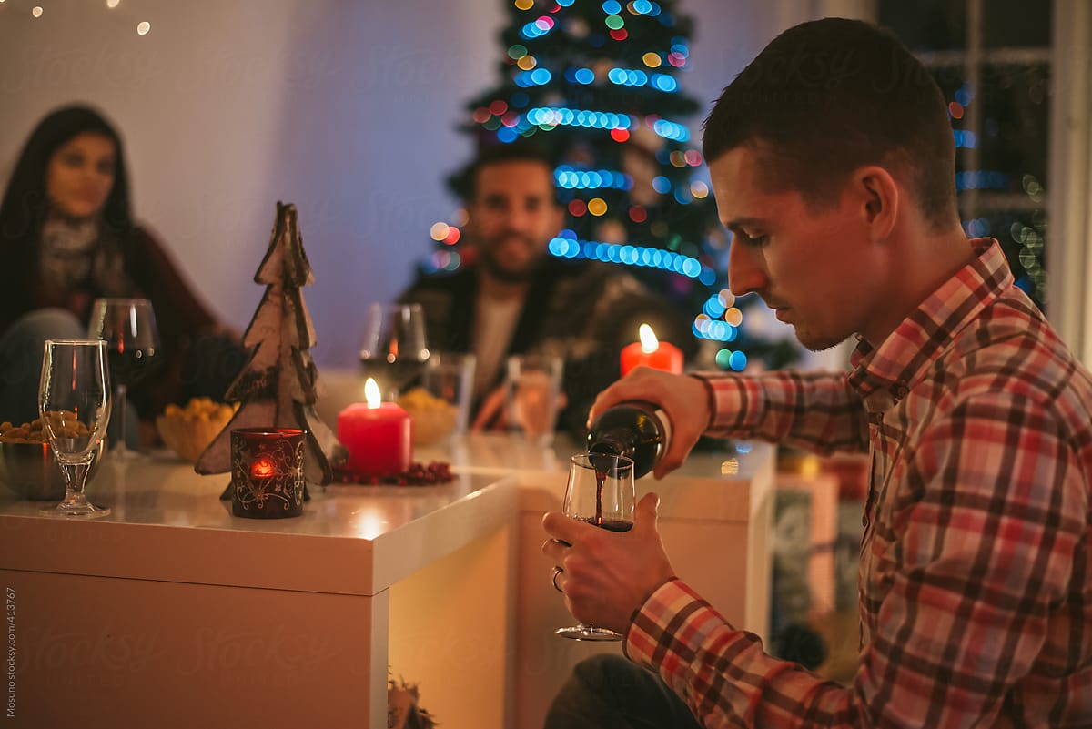 Man Pouring Wine for Christmas at Home