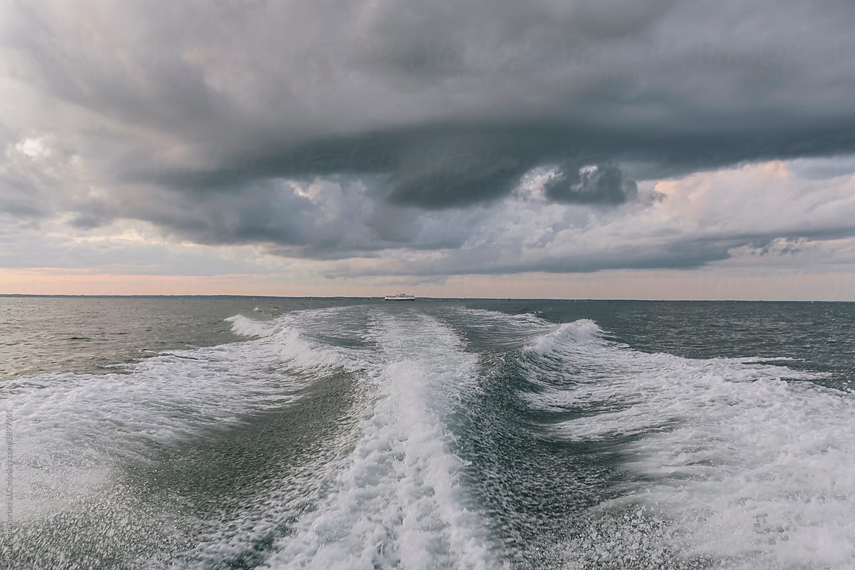 Gathering storm clouds off stern of boat