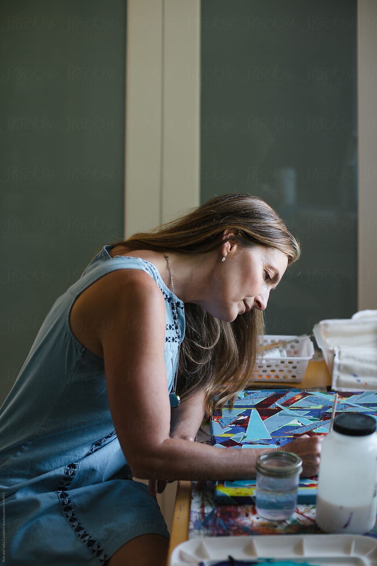 Healthy, artistic mature woman relaxing in art studio
