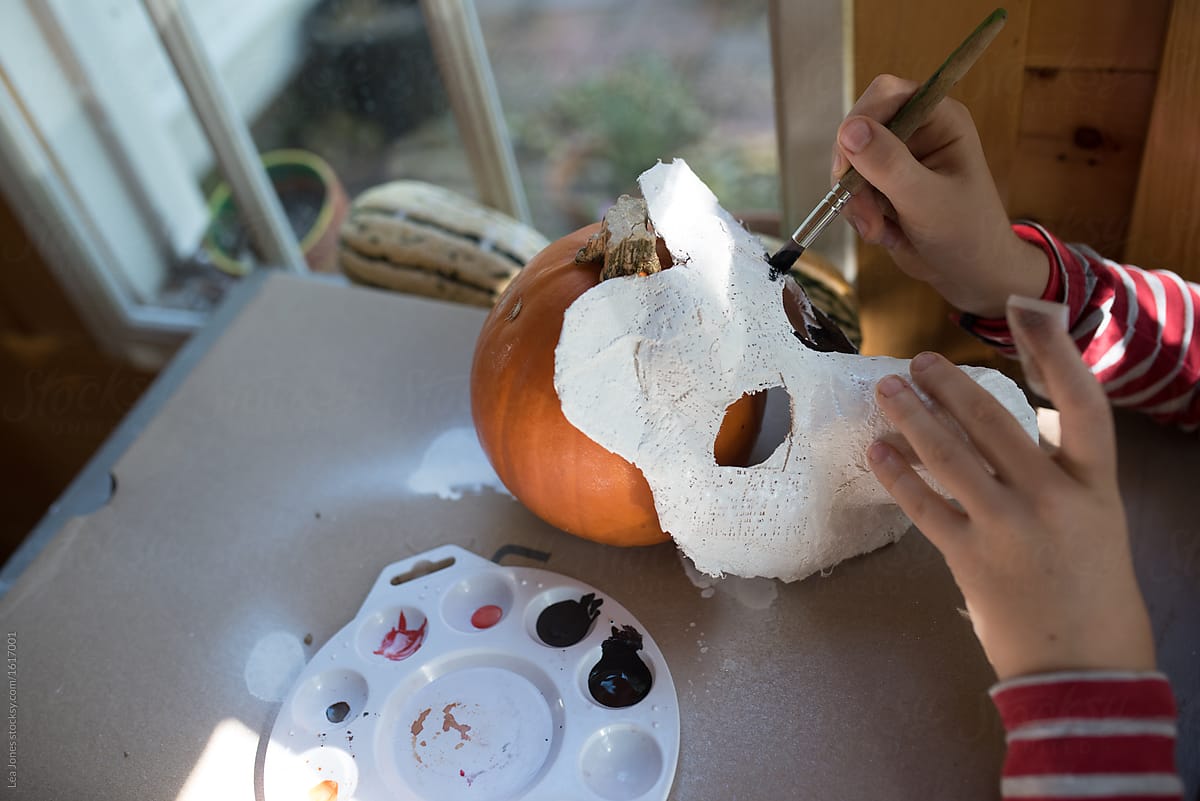 little boy making  a plaster panda bear mask